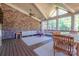 Inviting sunroom with vaulted ceiling, brick walls, ample seating, and views of the outdoors at 11224 Warfield Ave, Huntersville, NC 28078