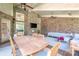 Enclosed sunroom featuring a brick accent wall, vaulted ceilings, and comfortable outdoor seating at 11224 Warfield Ave, Huntersville, NC 28078