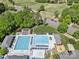 Aerial view of the community pool with lounge chairs and nearby golf course at 11510 Pine Valley Club Dr, Charlotte, NC 28277