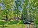 Serene backyard view with mature trees and green lawn, offering privacy and tranquility at 11510 Pine Valley Club Dr, Charlotte, NC 28277