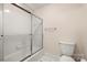 Well maintained bathroom features tiled walls, a toilet and a sliding glass door shower at 11510 Pine Valley Club Dr, Charlotte, NC 28277