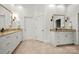 Bright bathroom features double sink vanities, sconce lighting, and tile floors at 11510 Pine Valley Club Dr, Charlotte, NC 28277