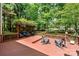 Expansive wooden deck with shaded seating area and views of the lush backyard at 11510 Pine Valley Club Dr, Charlotte, NC 28277