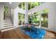 Open dining room featuring hardwood floors, a modern chandelier, and large windows overlooking the yard at 11510 Pine Valley Club Dr, Charlotte, NC 28277