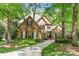 Charming brick home with lush green lawn and mature trees in a desirable neighborhood at 11510 Pine Valley Club Dr, Charlotte, NC 28277