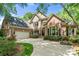 Beautiful two-story brick home with an attached garage, black shutters, and manicured landscaping at 11510 Pine Valley Club Dr, Charlotte, NC 28277