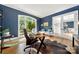 Bright home office featuring hardwood floors, a large window, a desk, and comfortable seating area at 11510 Pine Valley Club Dr, Charlotte, NC 28277