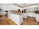 Well-lit kitchen featuring granite countertops, white cabinetry, and hardwood floors, perfect for cooking at 11510 Pine Valley Club Dr, Charlotte, NC 28277