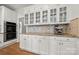 Bright kitchen with granite countertops, white cabinets, and glass-front display cabinets at 11510 Pine Valley Club Dr, Charlotte, NC 28277