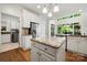 Open kitchen features granite countertops, stainless steel appliances, an island, and hardwood floors at 11510 Pine Valley Club Dr, Charlotte, NC 28277