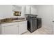 Well-lit laundry room features granite counters, stainless steel washer and dryer at 11510 Pine Valley Club Dr, Charlotte, NC 28277