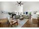 Cozy living room with hardwood floors, a piano, stylish furniture, and an open layout at 11510 Pine Valley Club Dr, Charlotte, NC 28277