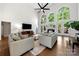 Spacious living room with high ceilings, large windows, hardwood floors, and comfortable seating arrangements at 11510 Pine Valley Club Dr, Charlotte, NC 28277