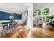 Open-concept home featuring dining and living spaces with hardwood floors, large windows, and stylish decor at 11510 Pine Valley Club Dr, Charlotte, NC 28277