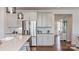 Well-lit kitchen with stainless steel appliances, white cabinets, and hardwood flooring at 11913 Casabella Dr, Huntersville, NC 28078