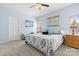 This bedroom boasts neutral walls, carpet floors, ceiling fan, and two bedside tables with lamps at 1221 Brookcrest Ln, Fort Mill, SC 29708