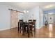 Dining room with stylish barn door, chandelier lighting, and hardwood floors, perfect for Gathering meals at 1221 Brookcrest Ln, Fort Mill, SC 29708