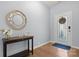 Bright foyer featuring hardwood floors, decorative mirror, and elegant entry door with glass paneling at 1221 Brookcrest Ln, Fort Mill, SC 29708