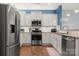 Well-equipped kitchen with stainless steel appliances, white cabinets, and granite countertops at 1221 Brookcrest Ln, Fort Mill, SC 29708