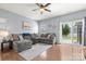Comfortable living room with hardwood floors, ceiling fan, and sliding glass doors leading to the backyard at 1221 Brookcrest Ln, Fort Mill, SC 29708