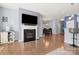 Inviting living room featuring a fireplace, hardwood floors, and open access to the dining and kitchen areas at 1221 Brookcrest Ln, Fort Mill, SC 29708