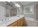 Bright bathroom features dual sinks, soaking tub, walk-in shower, and vanity with attractive lighting at 1607 Essex Hall Dr, Rock Hill, SC 29730