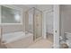 Bright bathroom features a soaking tub, walk-in shower, tile floor, and convenient toilet at 1607 Essex Hall Dr, Rock Hill, SC 29730