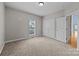 Neutral bedroom with plush carpeting, a double door closet and window with natural light at 1607 Essex Hall Dr, Rock Hill, SC 29730