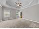 Bright bedroom with plush carpeting, a ceiling fan and an ensuite bathroom at 1607 Essex Hall Dr, Rock Hill, SC 29730