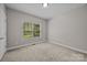 Bright bedroom with plush carpeting and a window overlooking the backyard at 1607 Essex Hall Dr, Rock Hill, SC 29730