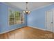 Bright dining room featuring hardwood floors, a chandelier, and large window at 1607 Essex Hall Dr, Rock Hill, SC 29730