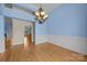 The dining room features a chandelier, hardwood floors, and detailed wall trim at 1607 Essex Hall Dr, Rock Hill, SC 29730