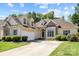 Attractive home with a two-car garage, and a combination brick and siding facade with a concrete driveway at 1607 Essex Hall Dr, Rock Hill, SC 29730