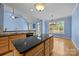 Bright eat-in kitchen with hardwood floors, an island and granite countertops at 1607 Essex Hall Dr, Rock Hill, SC 29730