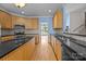 Updated kitchen with wooden cabinets, dark countertops and hardwood floors at 1607 Essex Hall Dr, Rock Hill, SC 29730