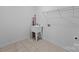 Bright laundry room features tile floor, utility sink and hook ups for a washing machine and dryer at 1607 Essex Hall Dr, Rock Hill, SC 29730