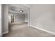 Large main bedroom boasts neutral carpet and walls, and tray ceiling, plus doorway to bathroom at 1607 Essex Hall Dr, Rock Hill, SC 29730