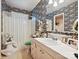 Well-lit bathroom with floral wallpaper, a vanity, and a shower-tub combination at 208 Armstrong Dr, Belmont, NC 28012