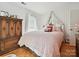 Charming bedroom featuring a draped canopy bed and classic wood armoire at 208 Armstrong Dr, Belmont, NC 28012