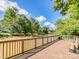 Scenic riverfront deck with wood railings and park bench with views of the serene water at 208 Armstrong Dr, Belmont, NC 28012