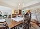 Dining room with hardwood floors, chandelier, and a view into the living room at 208 Armstrong Dr, Belmont, NC 28012