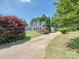 Beautiful home with dormers, a long driveway and lush green landscaping creating great curb appeal at 208 Armstrong Dr, Belmont, NC 28012