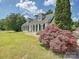 Well-maintained one-story home showcasing lush landscaping and a driveway at 208 Armstrong Dr, Belmont, NC 28012