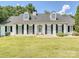 Charming one-story brick home with black shutters and a manicured lawn at 208 Armstrong Dr, Belmont, NC 28012