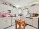 Well-lit kitchen featuring white cabinetry, tile countertops and a wooden island at 208 Armstrong Dr, Belmont, NC 28012