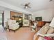 Cozy living room featuring brick accent wall, comfortable seating, and a ceiling fan at 208 Armstrong Dr, Belmont, NC 28012