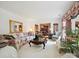 Bright living room featuring floral sofa and a view into the dining area at 208 Armstrong Dr, Belmont, NC 28012