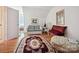 Living room with hardwood floors, sitting area and decorative oval rug at 208 Armstrong Dr, Belmont, NC 28012