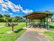 Covered picnic area in a lush park setting with picnic tables and a barbecue grill at 208 Armstrong Dr, Belmont, NC 28012