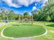 A playground with swings and climbing structure surrounded by green artificial turf at 208 Armstrong Dr, Belmont, NC 28012
